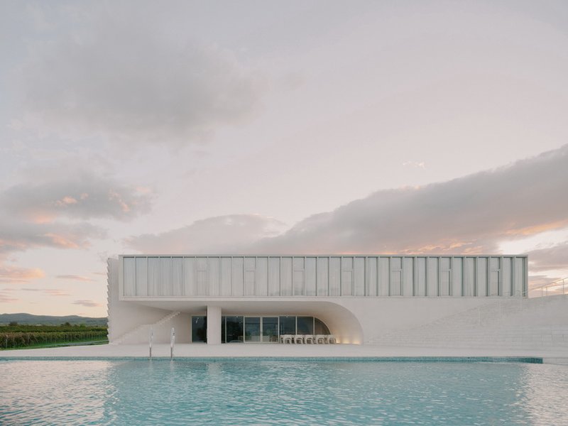 arches and voids carve winery’s monolithic white facade in georgia