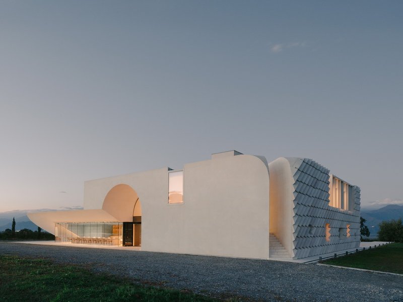 arches and voids carve winery’s monolithic white facade in georgia
