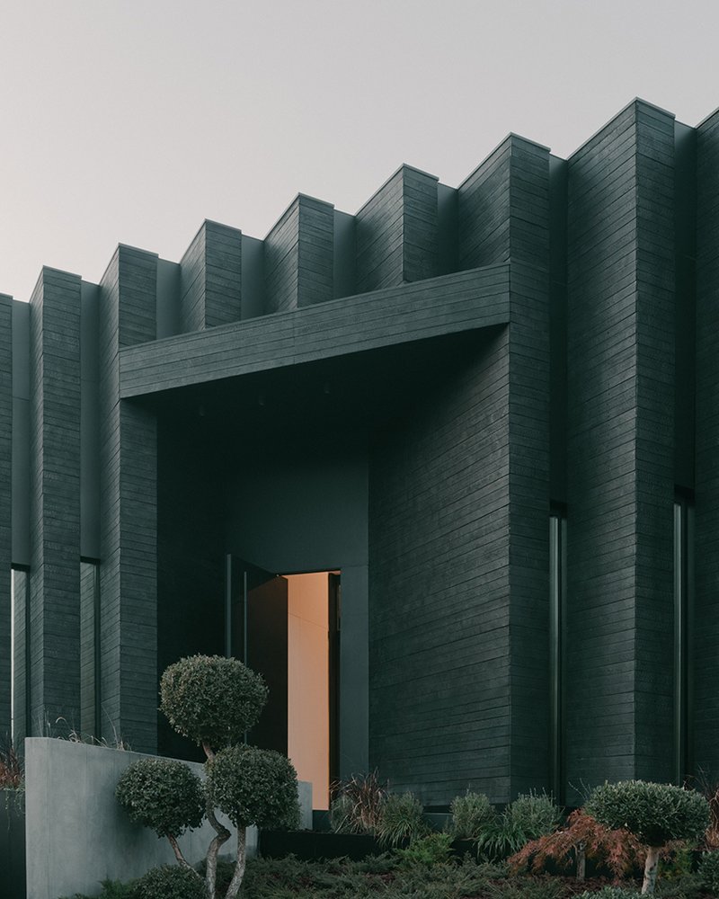 serrated charred wood shell encloses suburban residence on the hills of tbilisi